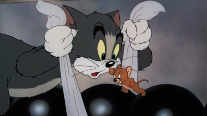 A little kitten playing bowling,