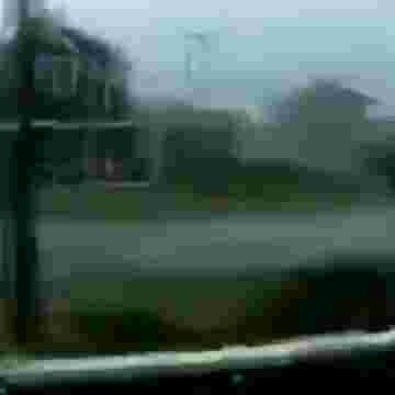 THERE'S A PERSON SURFING A HUGE WAVE OUT THERE