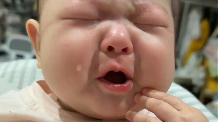 A pale, smooth little face, glistening teardrops—what a delicious-looking child!
