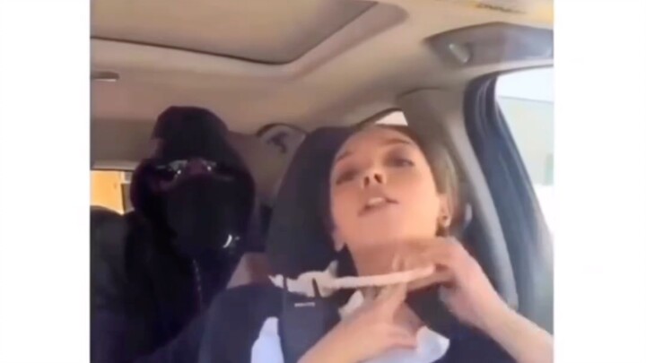 A beautiful female police officer demonstrates how to defend yourself against a rear-nape choke—yet 