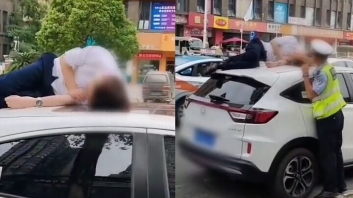 Một người đàn ông ngủ quên trên nóc xe ô tô sau khi uống rượu và được cảnh sát giao thông đánh thức 
