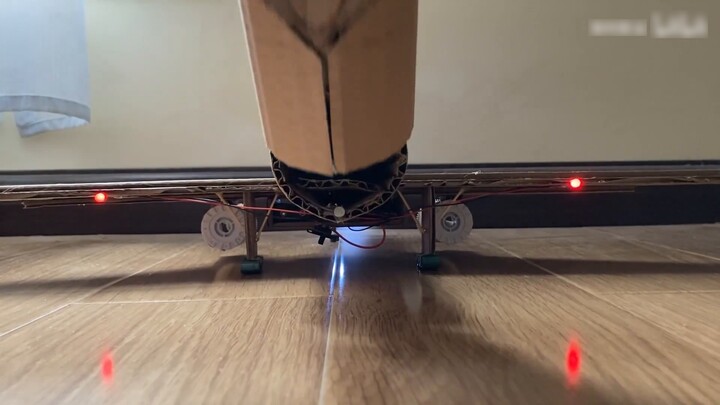 The handsome guy is making an airplane from cardboard at home, he is so handsome