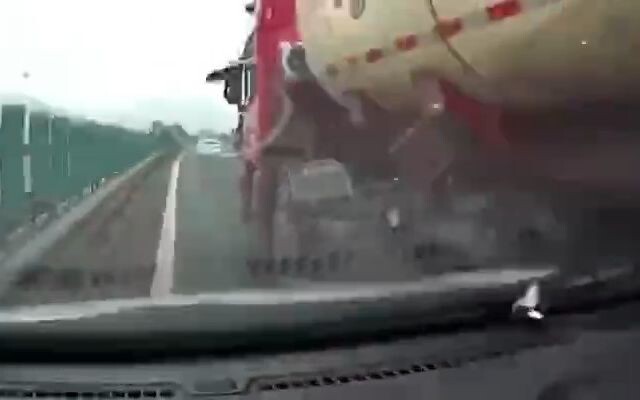 The small car was tragically crushed by a cement truck.