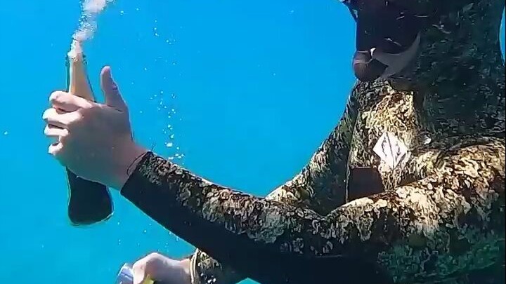 What happens when you open a bottle of full-bodied cola at the bottom of the ocean? The scene is too
