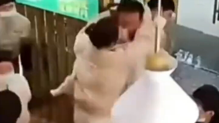 Man delivers a palm strike to his opponent after a meal and is collectively fought back by the waits