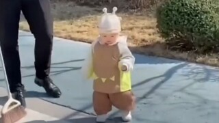 Mom lets baby walk on their own; Dad's approach is unexpected.