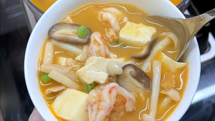 Mom’s salted‑egg, three‑delicacies, mushroom, and tofu soup!! So, so, so delicious! I really love th