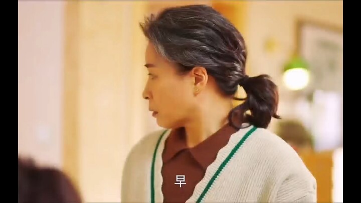 She seems like her mother-in-law wants to laugh but can’t—any smile would make her look just like a 