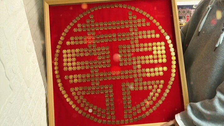 A handmade coin art piece of the double happiness symbol—I hope my girl will have a hundredfold joy 