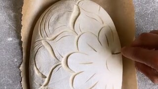 Scoring sourdough bread—it's truly an art form. The baked result is absolutely stunning!