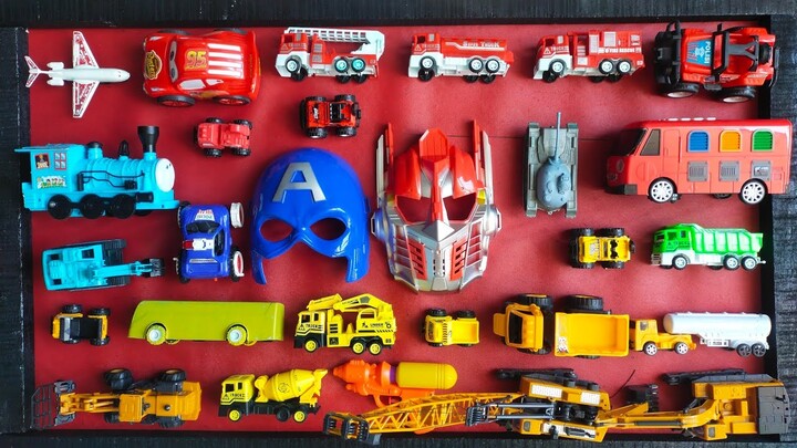 menemukan mainan pesawat, truk, mobil polisi, topeng superhero, tank, mpbil pemadam, tayo, excapator