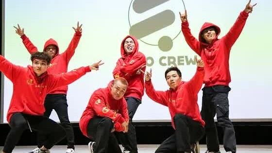 [Breaking group dance performance on campus. Girls screaming wildly in the audience] (Breaking tutor