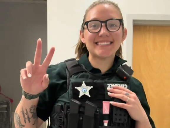 American female police officers show off their workday uniforms, and the uniforms still show off the
