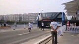 Train running across the road in China.