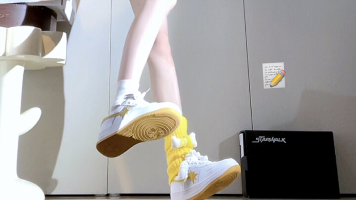 Even in school pants, this yellow looks amazing on her.