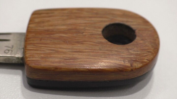 1. Wooden door key, made of light brown and dark brown bamboo, with a polished finish.