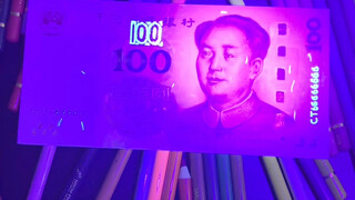 Tôi dùng đèn để rút tờ 100 nhân dân tệ.