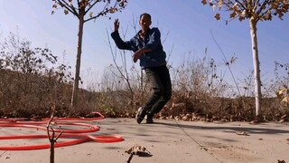 The old man in the countryside was interested in watering the trees, so he put down the water pipe a