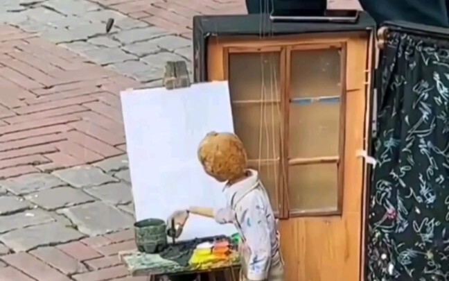 Is this a bit too over the top—using a puppet to draw?