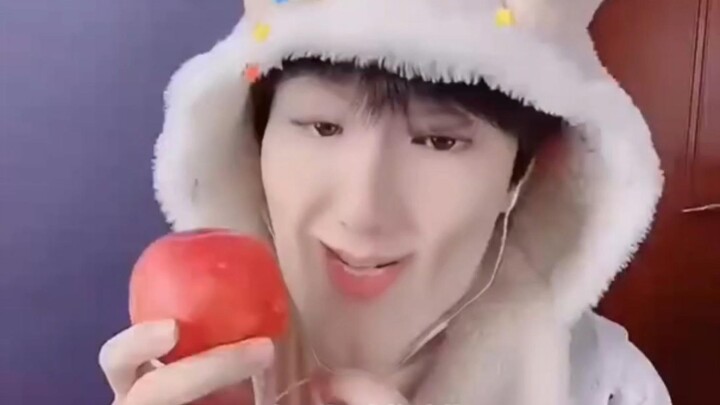 A tough guy eats a peach
