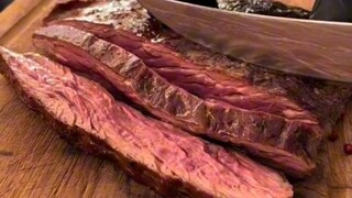 مطعم لحم مشوي في رومانيا، بعد التقطيع يتم صب الصلصة الحارة المذابة عليه، يبدو لذيذًا.