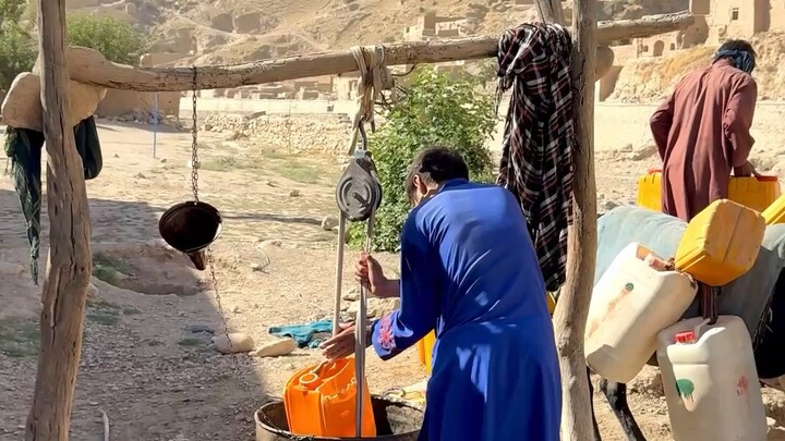 Giving water to donkeys from a local well. Badghis - Afghanistan