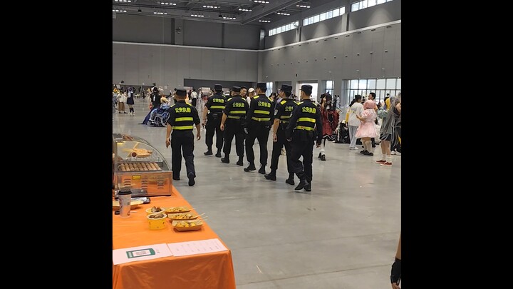 Anime fans who just finished military training are patrolling and assisting police at a comic conven