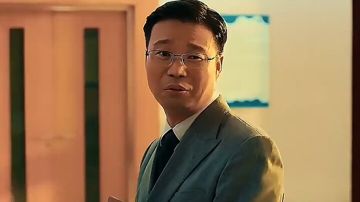 Big slicked-back hair, glasses, and buck teeth—his name is Wang Xun.