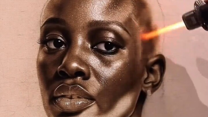 Have you ever seen someone paint on a canvas using fire?