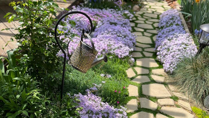 Teaching everyone how to pave a garden path.