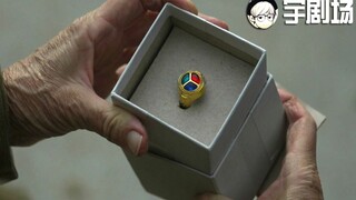 An old man receives a ring; after putting it on, he crushes a football with his fingers, lifts a tre