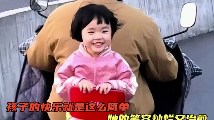 A child’s joy practically spills off the screen! The little girl on the electric bike’s back rides i