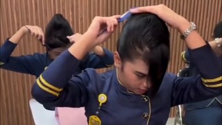It turns out that flight attendants all have their hair in a bun like this!