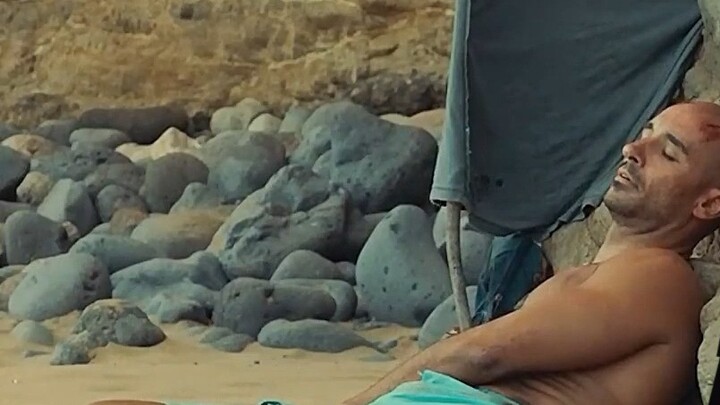 Man trapped on cliff, trying to survive under scorching sun