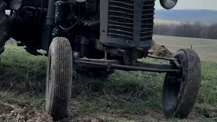 A farmer plows his field with a tractor