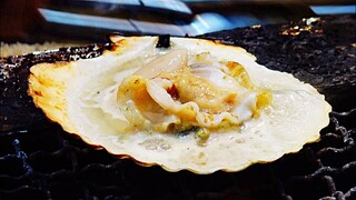 GRILLED SCALLOPS CUTTLEFISH with soy sauce Japanese street food at Kuromon Osaka