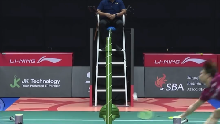 Badminton: hands up in defeat—kid, you’ve still got a lot of work to do.