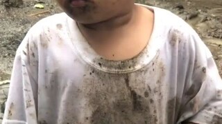 Kid enjoying the rain and got dirt from the mud