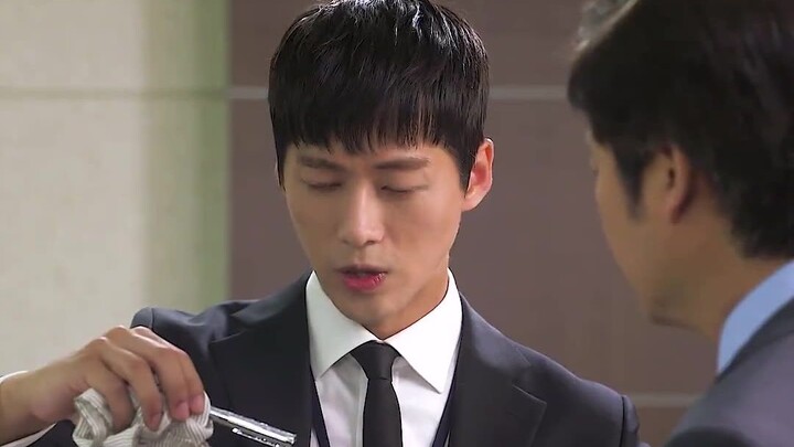 The man knocked over the water cup and the silver pen that was soaked in water instantly turned blac