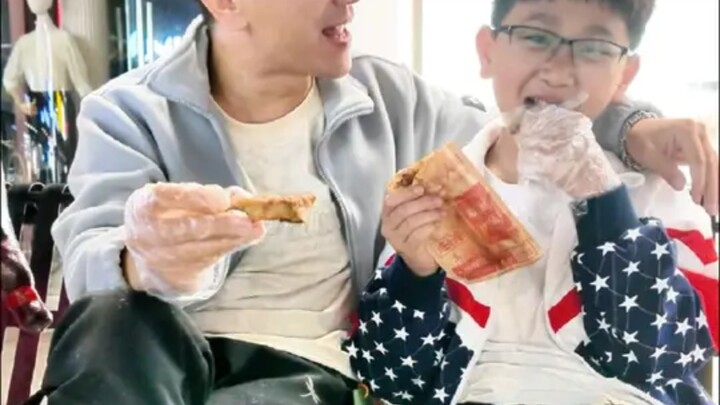 A harmonious scene of father and son enjoying roasted pig's trotters, sharing heartfelt talks late a