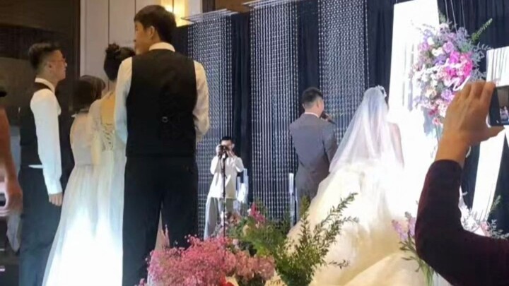 At the wedding, the groom snags the bouquet and bolts straight to his girlfriend—looks like he just 