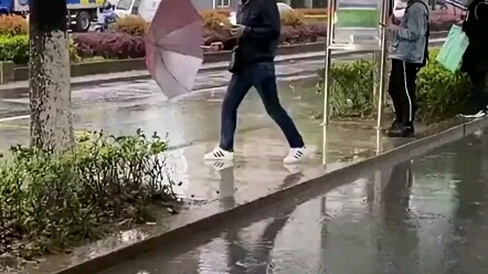 A passerby waiting for the bus in the rain got splashed all over!