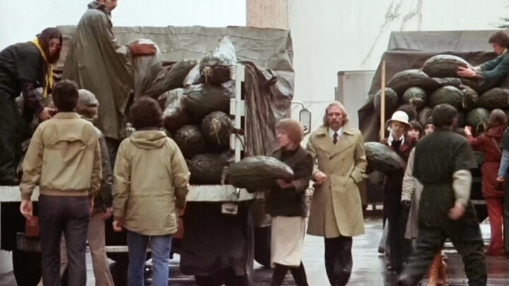 A man steps outside and sees everyone clutching bizarre plants—little does he know, they’re actually