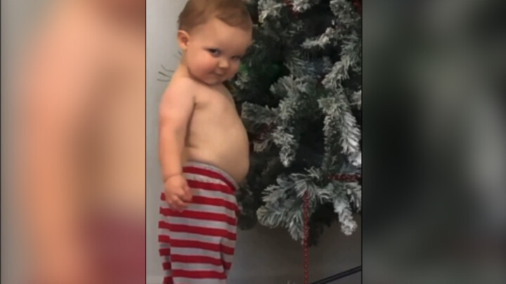 A human baby with a charming, mischievous smile