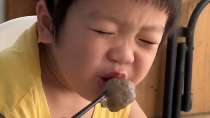 A little kid’s reaction after scalding their mouth—blushing, flustered, and dazed.