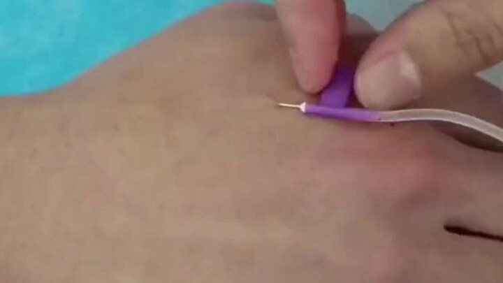 Medical student practicing IV insertions—every time they withdraw the needle, it draws blood.