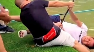 Three strong men team up to subdue a giant fish