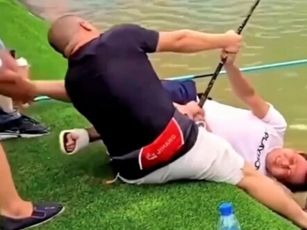 Three strong men team up to subdue a giant fish