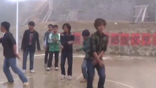 Early campus dance rehearsals—though the cement by the village entrance remains, that red-haired mon