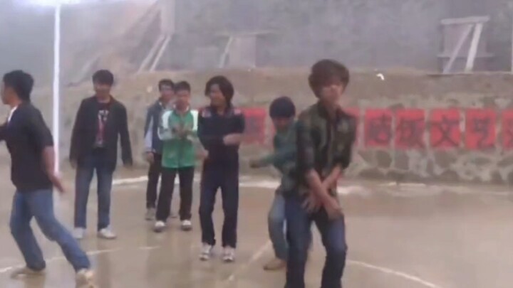 Early campus dance rehearsals—though the cement by the village entrance remains, that red-haired mon